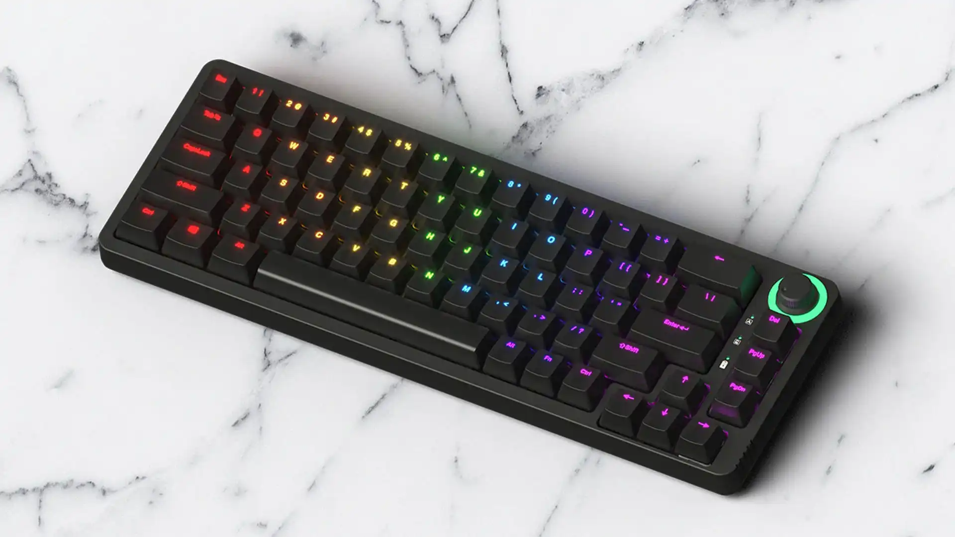Compact black mechanical keyboard with vivid rainbow backlighting and a glowing green rotary knob on a white marble surface