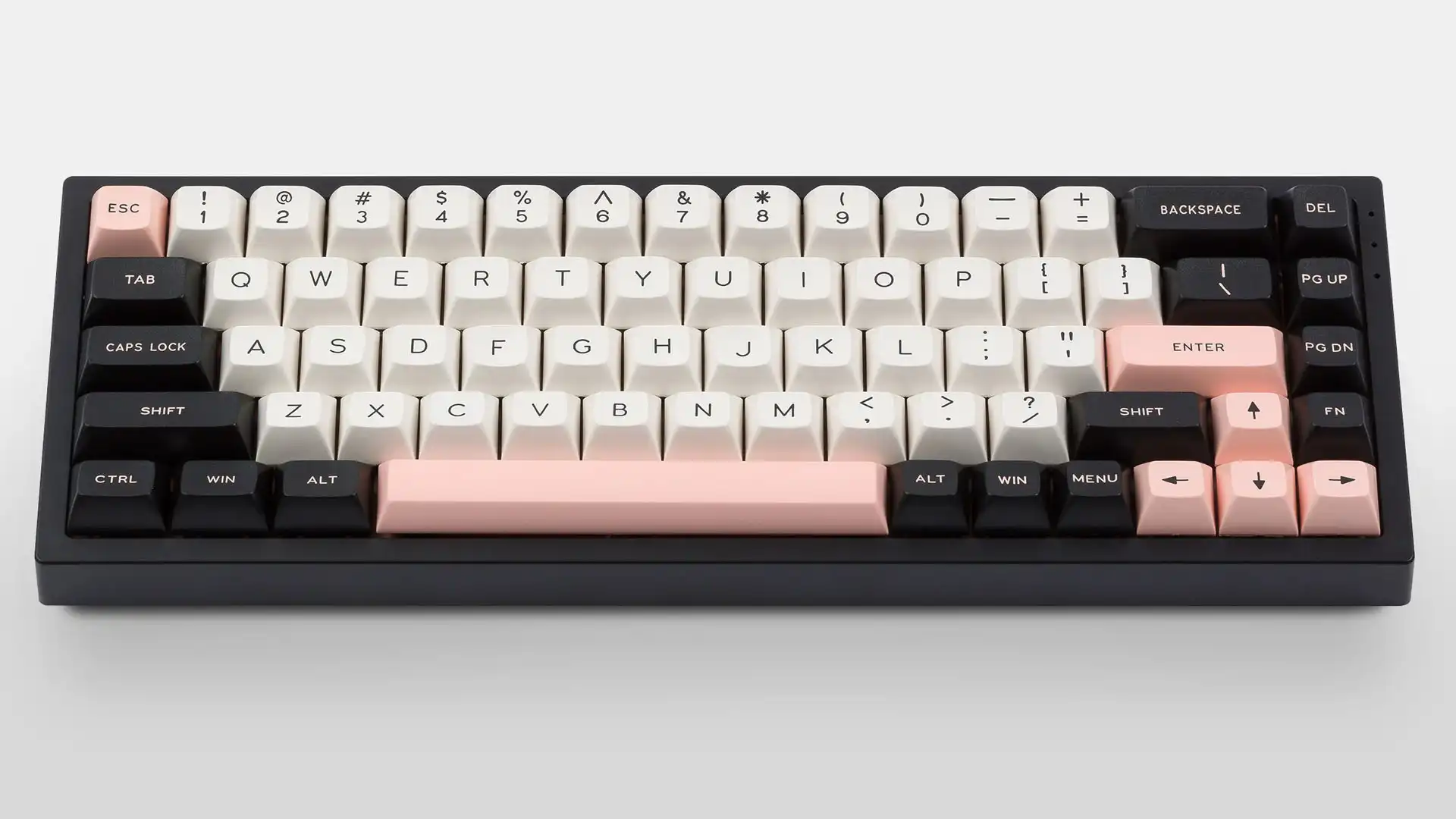 Compact mechanical keyboard with cream and pink keycaps and black frame on a plain light background