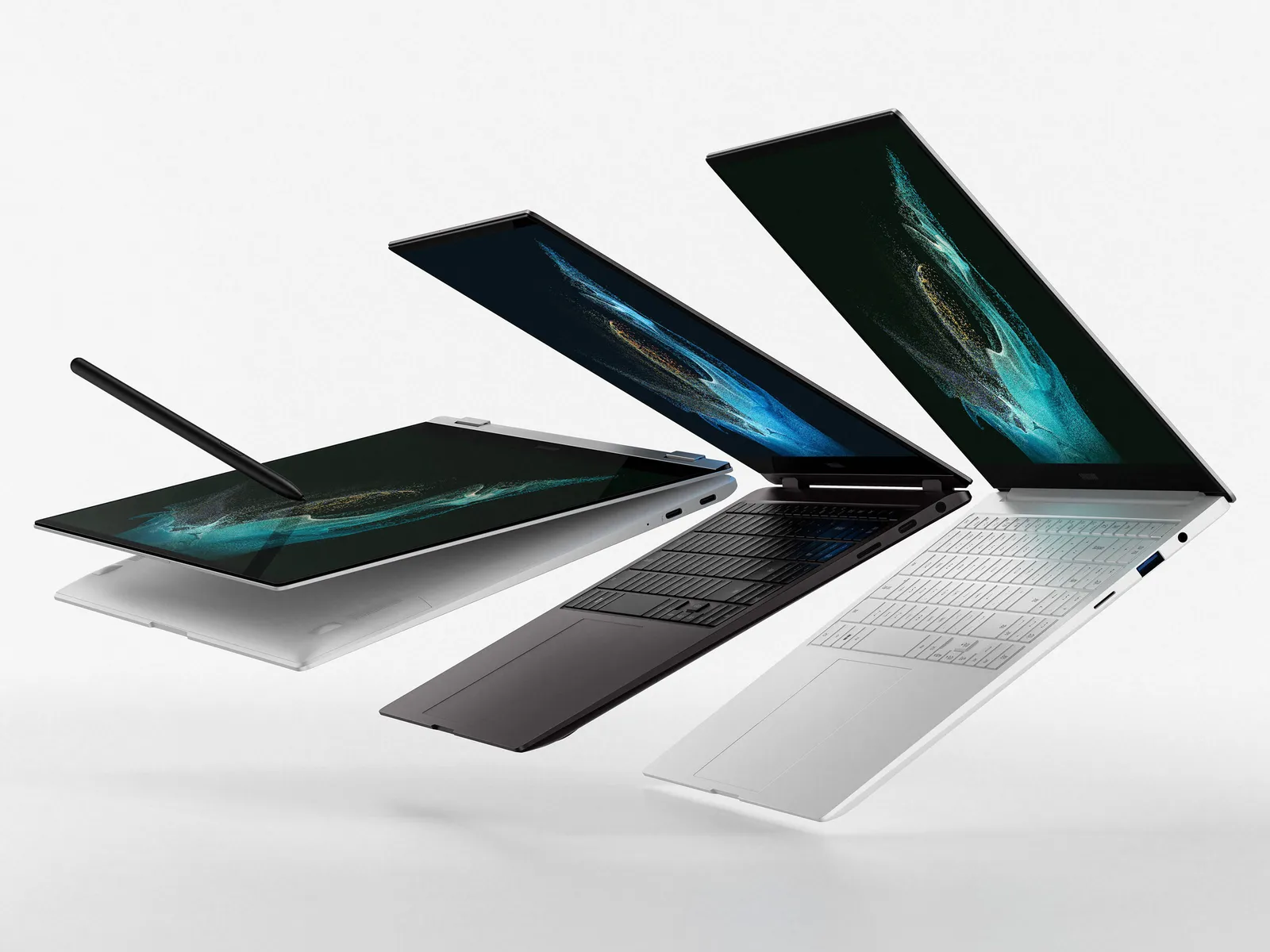 Three laptops in different colors shown open at various angles with abstract teal and blue wallpaper on screens, plus a smartphone